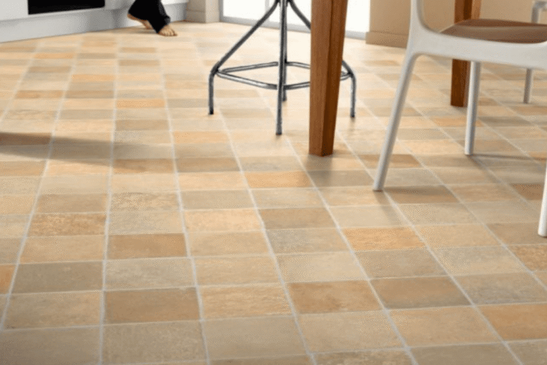 Kitchen and dining area with stone-look vinyl sheet flooring laid in a tiled pattern