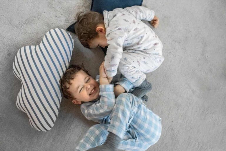 Two young children playing on soft, family-friendly carpet flooring.