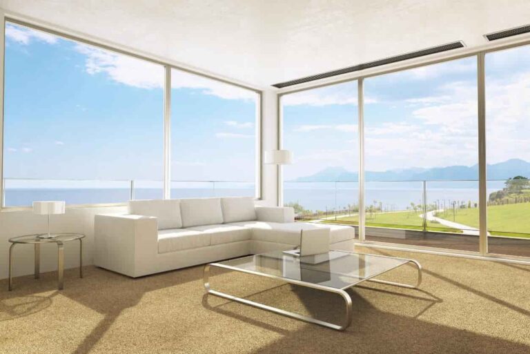 A bright, living room featuring neutral carpet