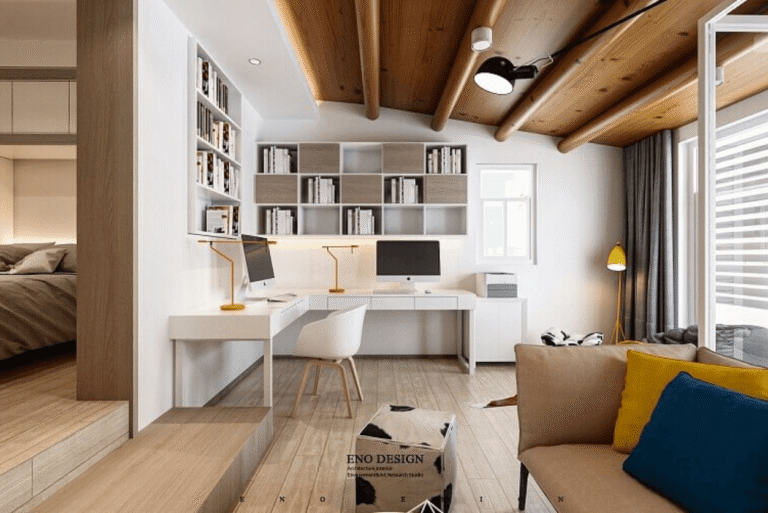 A corner office in a living area adjacent to a bedroom