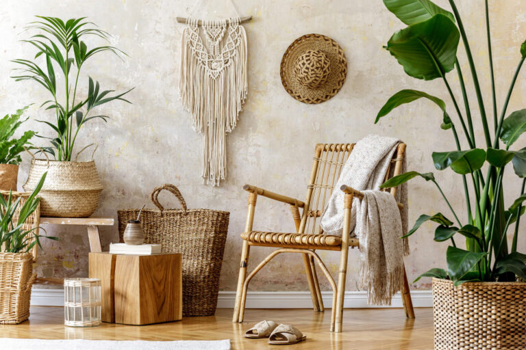 Indoor room with rattan chair, woven baskets, plants, and wall décor.