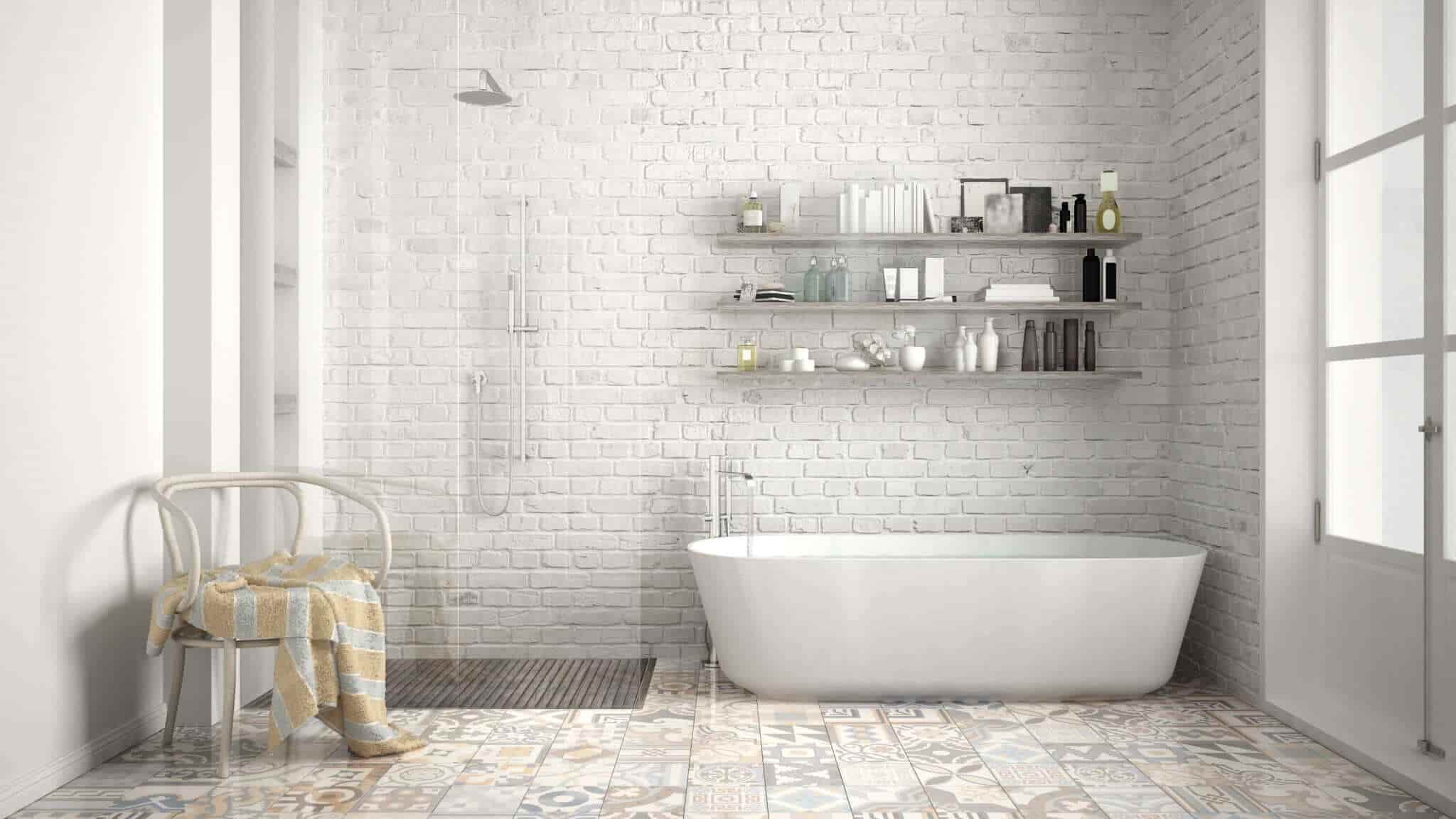Bathroom featuring white brick wall, enclosed shower, white tub, and patterned tile flooring