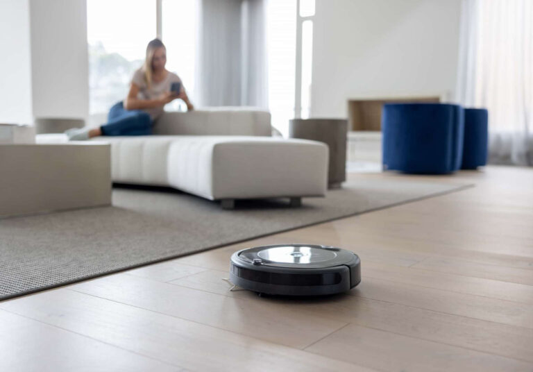Robot vacuum cleaning hybrid vinyl plank flooring in a modern living area.