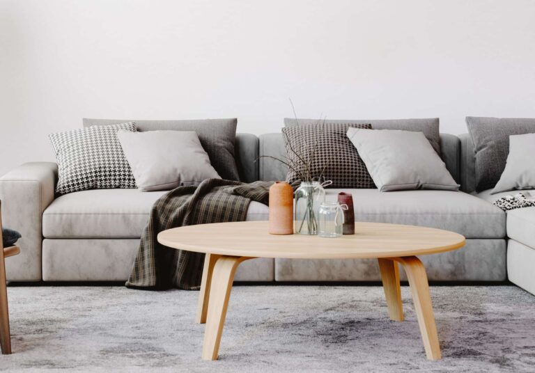 Neutral living room with sofa and coffee table on wool carpet.