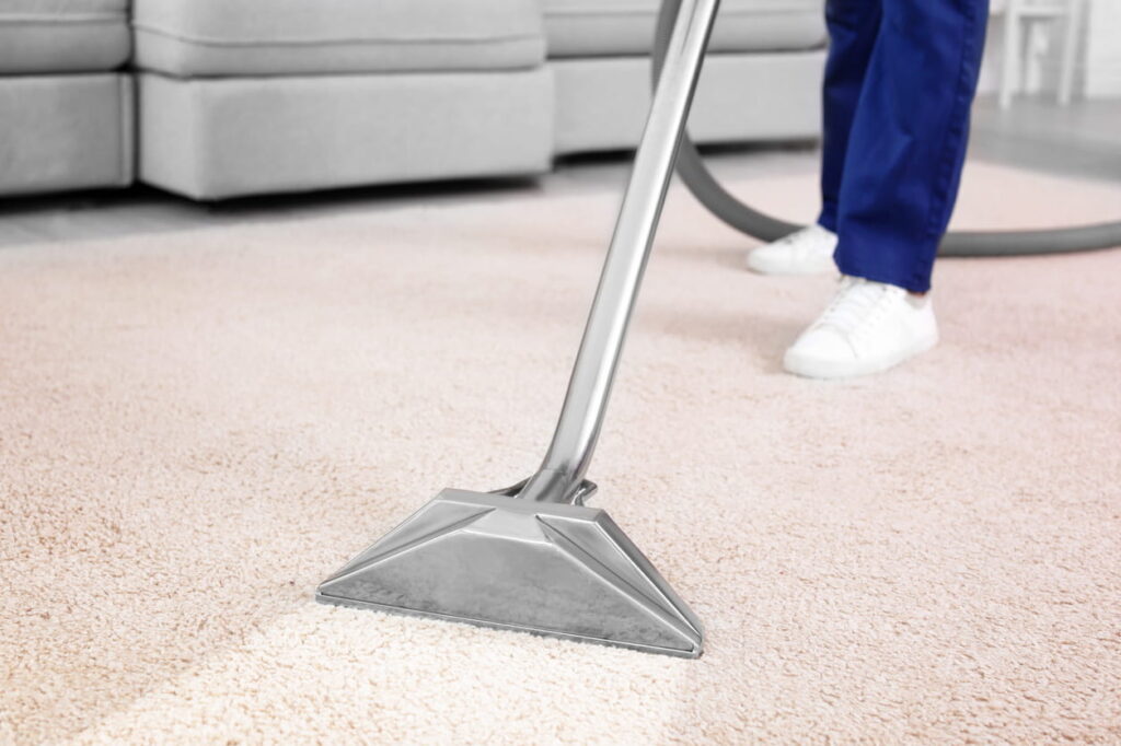 Professional carpet cleaning machine in use on light-coloured carpet