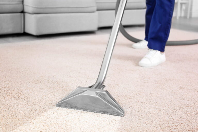 Professional carpet cleaning machine in use on light-coloured carpet