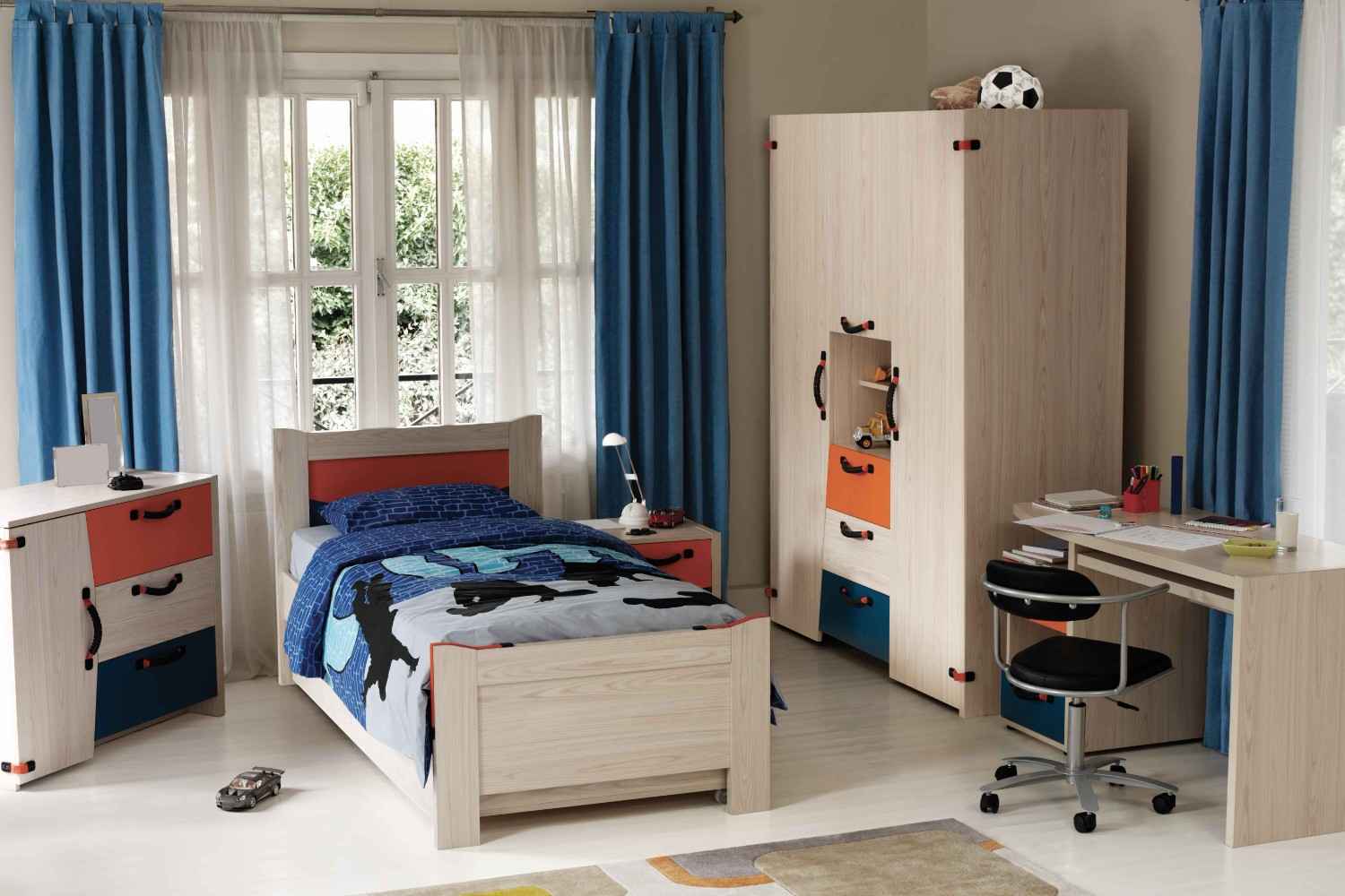 A kid's bedroom with the bed against the window that is fitted with white and blue curtains.