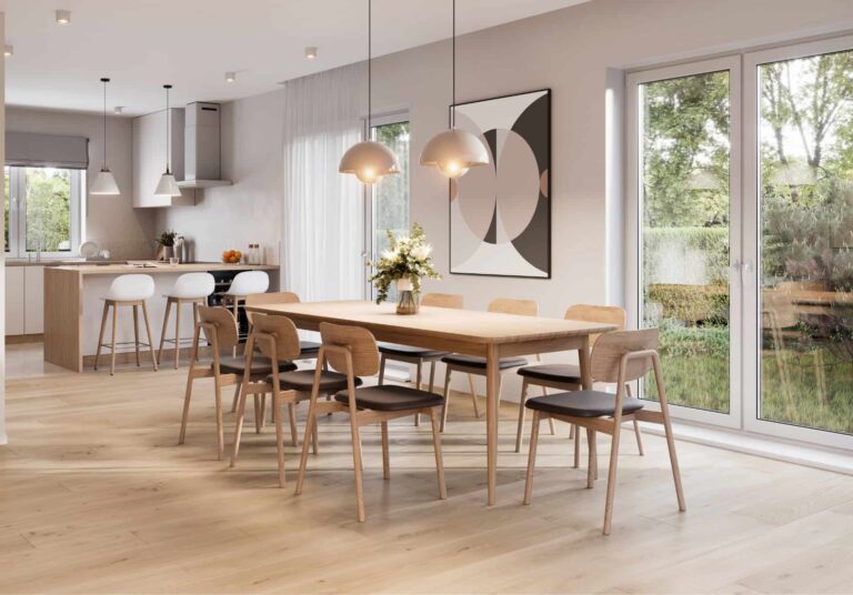 Bright dining and kitchen space with light wood laminate flooring and large windows