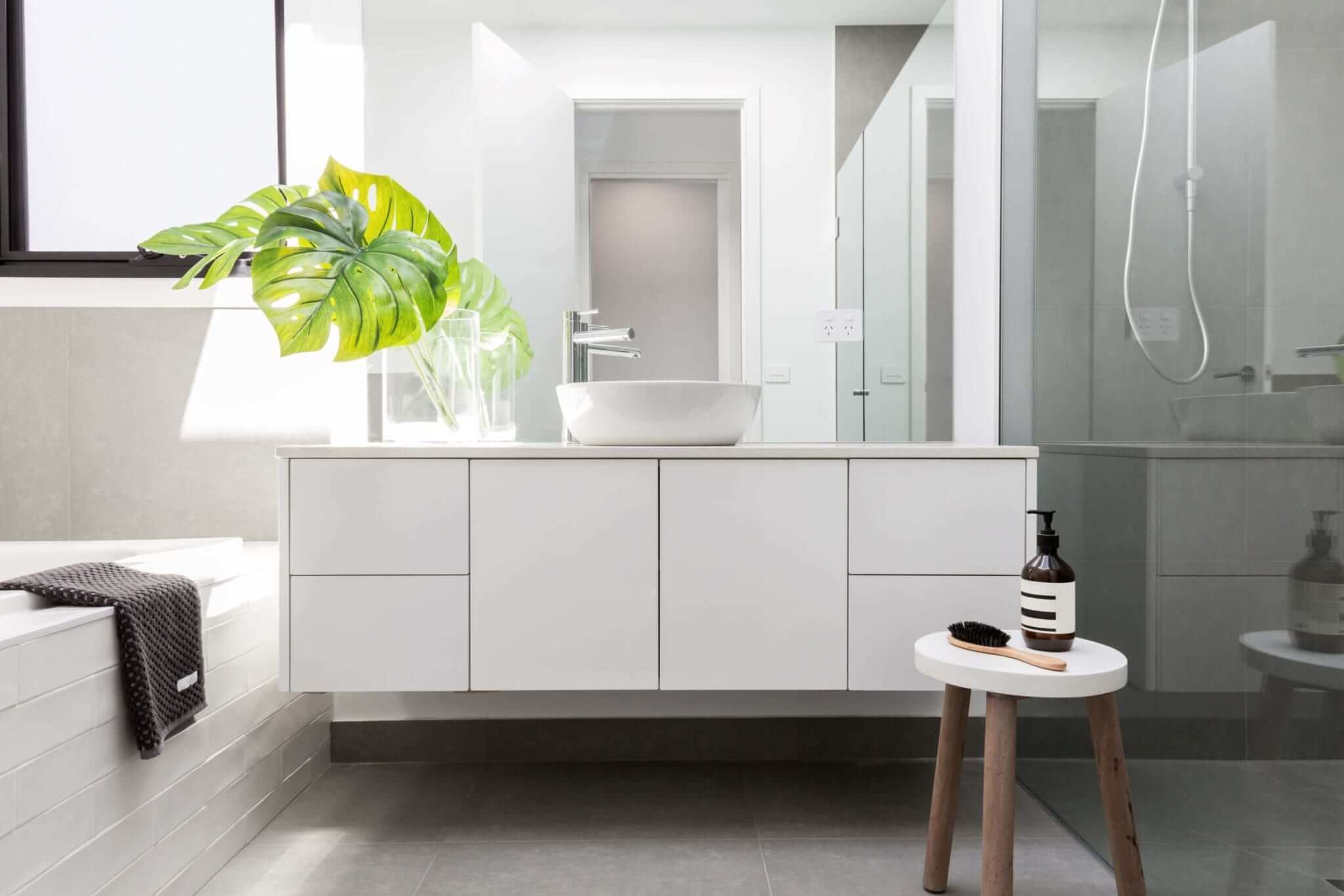 A bathroom featuring white fixtures and tub and neutral flooring