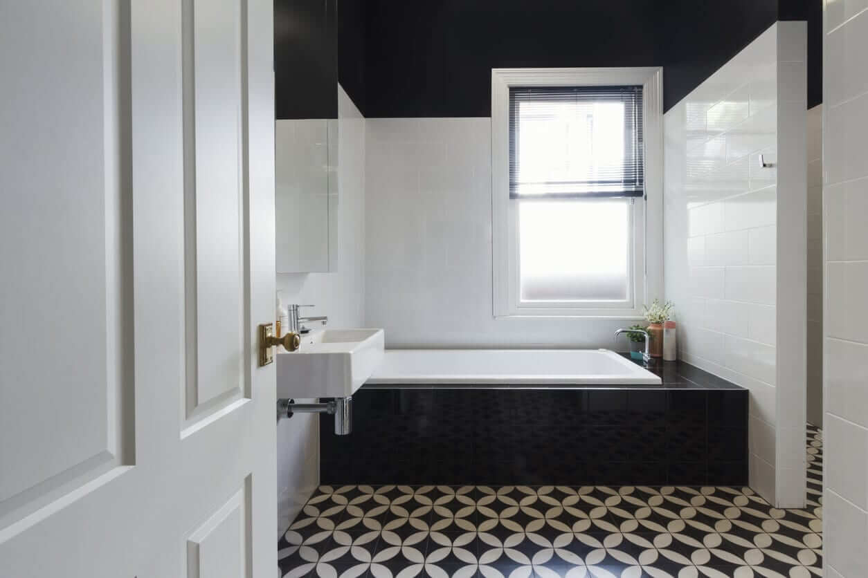 A bathroom featuring black & white patterned flooring