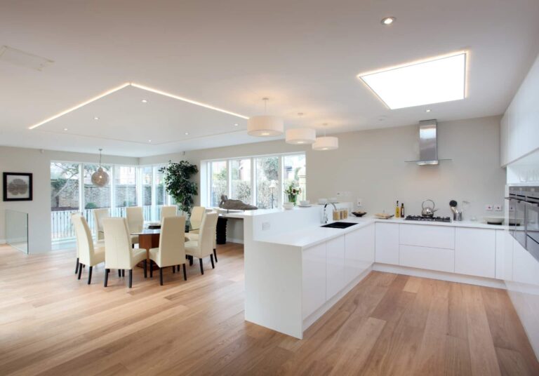 An open-plan kitchen and dining area with natural timber flooring.
