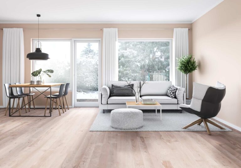 Open-plan living and dining area with light-toned engineered timber flooring