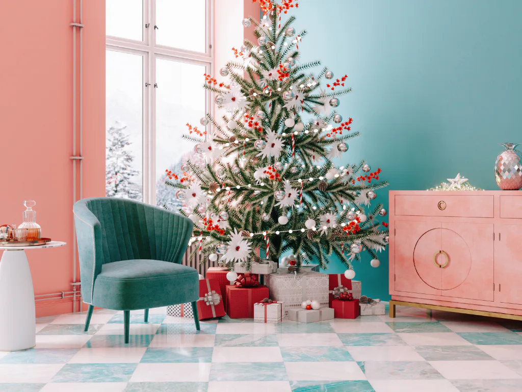 Contemporary living room featuring a decorated Christmas tree with white and red ornaments, green fern branches, surrounded by wrapped red and white gifts. A teal velvet armchair and pink cabinet c...