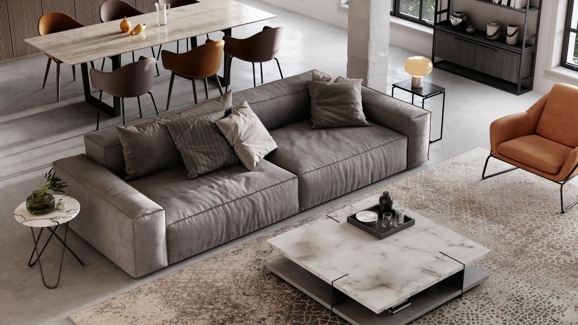 Contemporary open-plan living room featuring a large gray sectional sofa with decorative pillows, marble and black metal coffee table, cognac leather accent chair, and dining area with upholstered ...