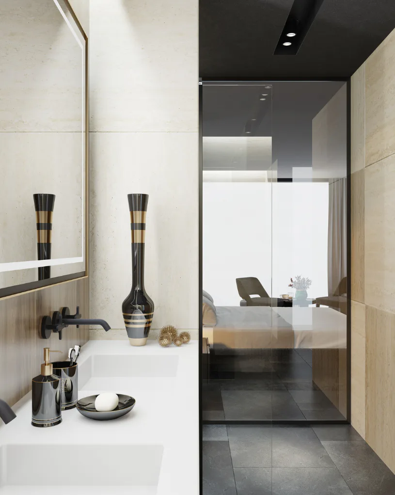 Contemporary bathroom featuring white marble vanity with black metal faucet, decorative black vases with gold bands, dark floor tiles, and glass-enclosed shower area with view to bedroom beyond.