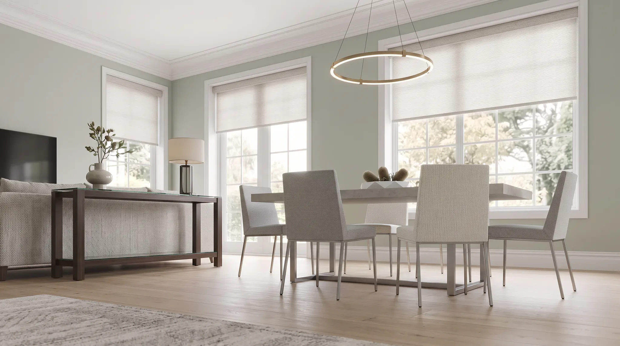 Bright modern dining room featuring a light wood table with four upholstered chairs, pendant lighting, sage green walls, large windows with white roller blinds, wooden flooring, and contemporary fu...